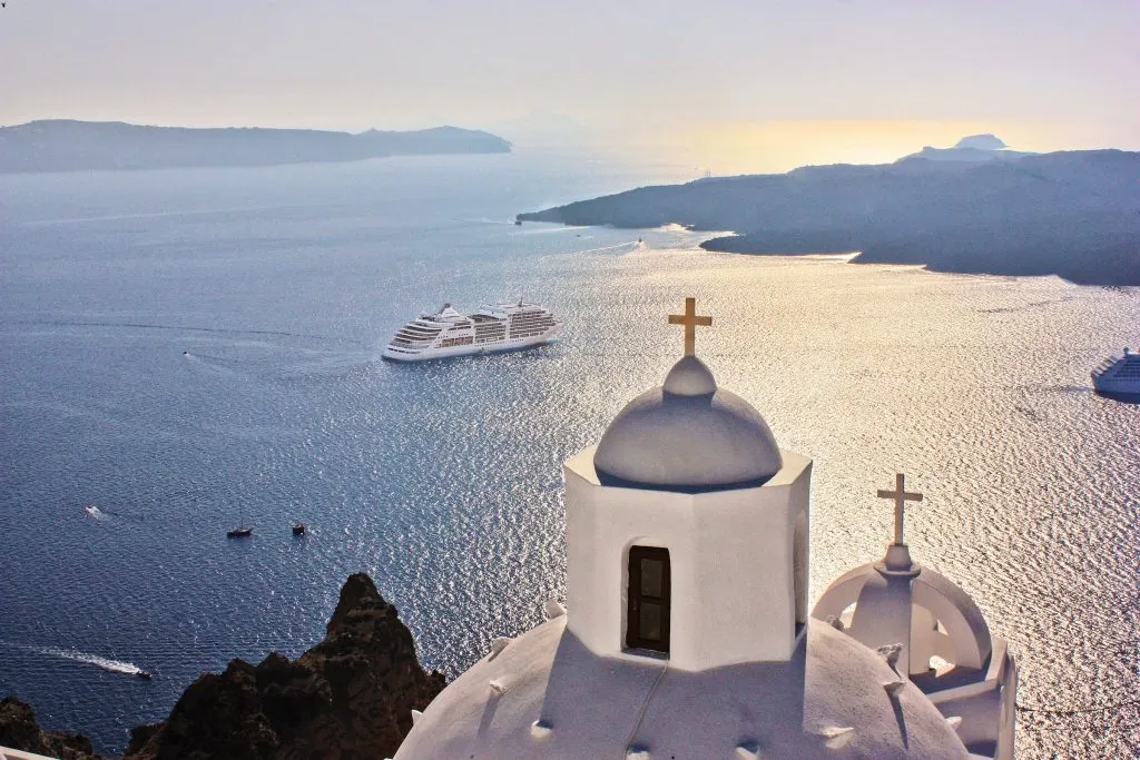 santorini church and cruise ship at sea